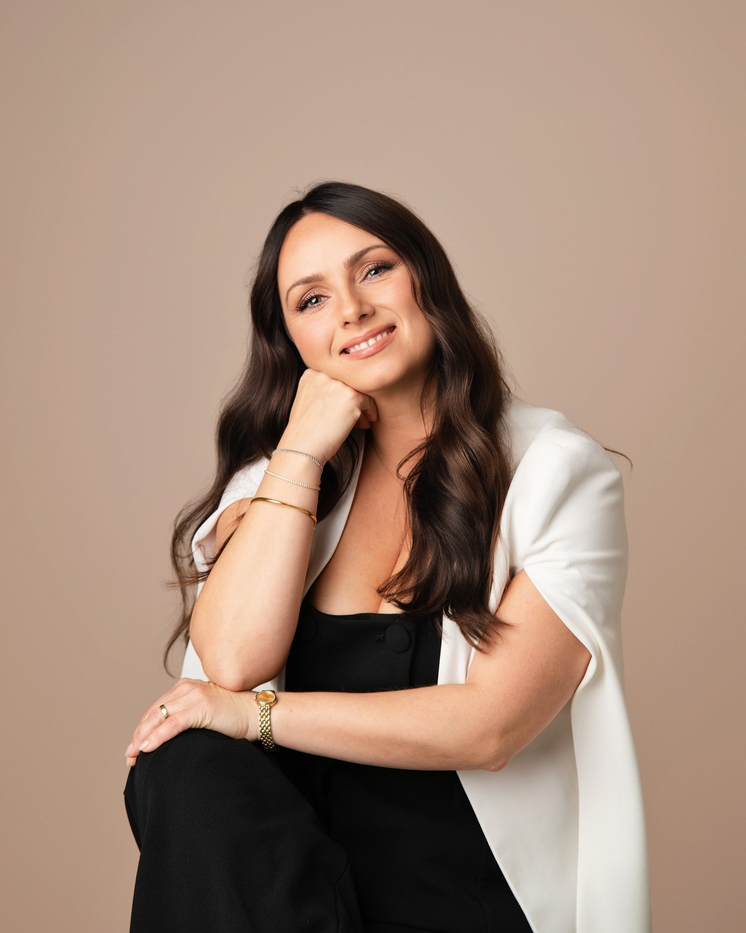 Sally Ashworth, nutritional therapist and yoga teacher, smiling in a white blazer
